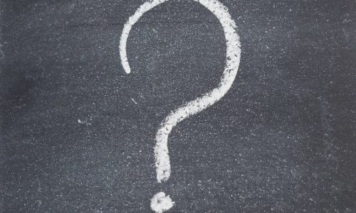 Chalkboard with a question mark written on it isolated against a white background